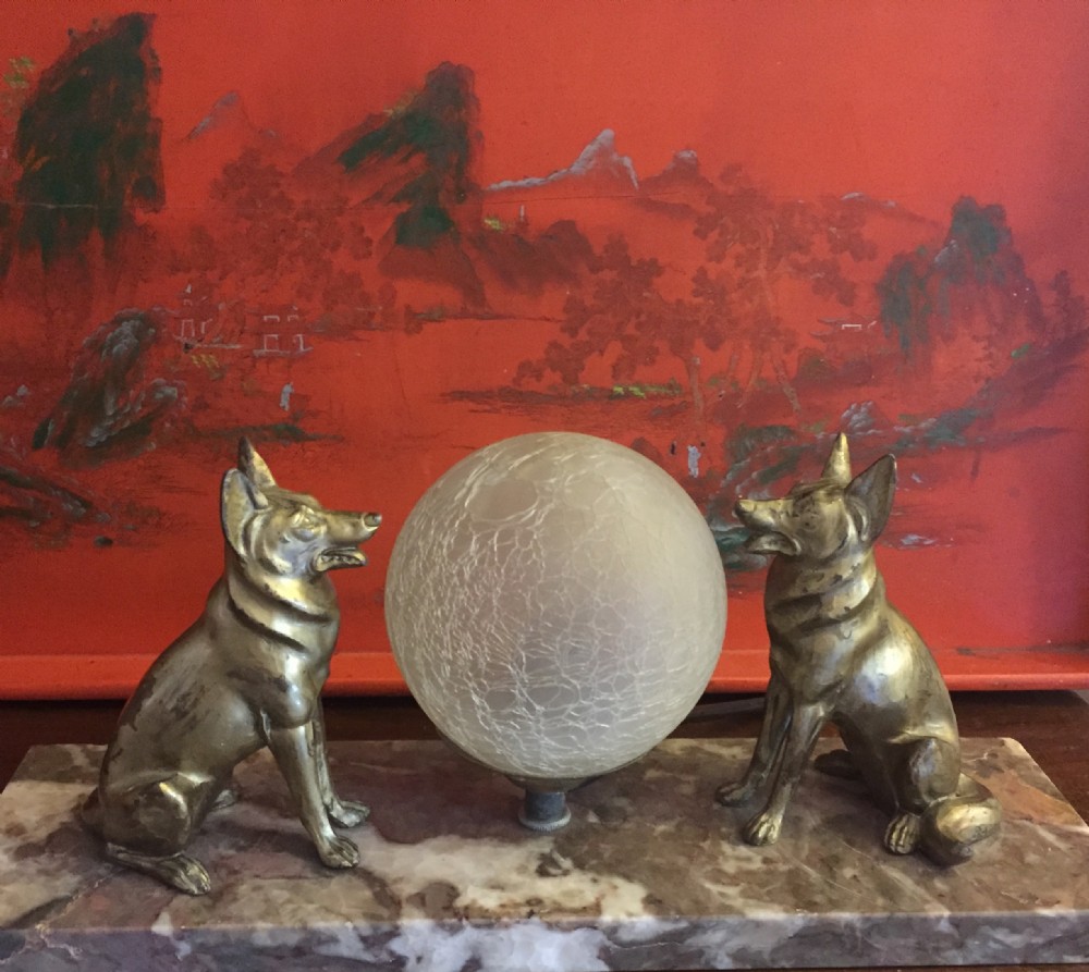 large art deco night light glowing on two alsatians on marble